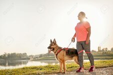 59142002-happy-young-woman-jogging-with-her-german-shepherd-dog.jpg