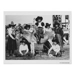 Seven rodeo cowgirls jokingly posing with a donkey poster.jpg